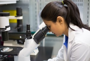 Woman Looking Through Microscope