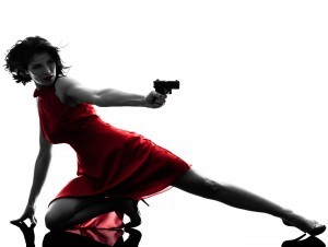 one sexy caucasian woman holding gun in silhouette studio isolat