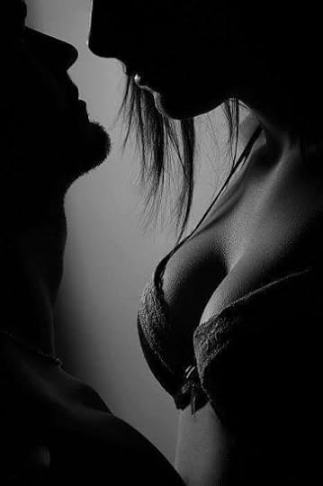 gorgeous woman with perfect breasts and silky skin in a lace bra teases her lover with a kiss