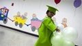 REUTERS/Carlos Garcia Rawlins -A girl plays with balloons on the last day of classes at Cacique Tiuna Commune's preschool in Caracas July 9, 2010. Tucked into forested hills in southwest Caracas, a red-brick housing complex for the poor is a testing ground for Venezuelan President Hugo Chavez's latest step to build socialism in the Latin American oil producer. The phalanx of simple five-storey apartment blocks, some still being built, anchors the 
