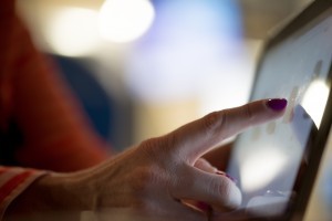 photo of someone touching a tablet screen
