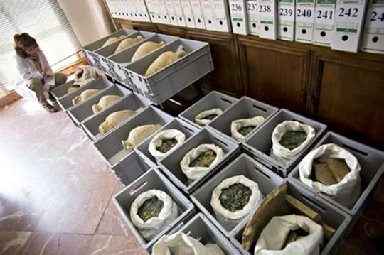 Some of the amphorae and coins that were unearthed in Tomares, Spain.