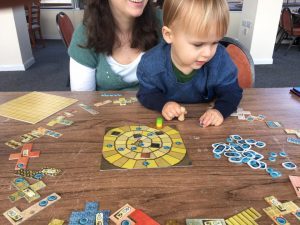 Sammy helping to play Patchwork by Mayfair Games at the Dice Cup