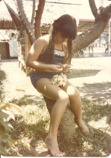 Daughter Number One gathering kalachuchis, aka plumeria or fragipani