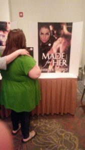 Dawna getting ready to stick her kiss to the Made For Her cover at Hot Bodies and Naughty Kisses.