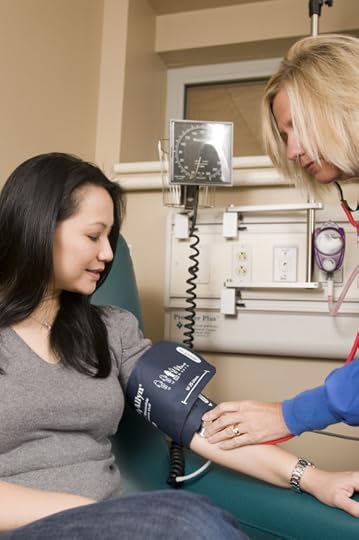 Nurse administering a blood pressure exam. Public Domain via FreeStockPhotos.biz.