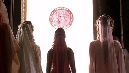In front of an open door with blinding bright white light showing through a curtain with Octavian's picture on it, we see Atia from behind, standing in the center of and just slightly ahead of Livia and Octavia. It's really powerful, as Atia is framed by the doors and you get a sense that it's really her triumph, more than Octavian's.