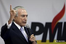 Brazil's Vice President Michel Temer speaks during a meeting with members of the Party of the Brazilian Democratic Movement (PMDB) in Brasilia May 7, 2015. For the last 20 years, Brazil's largest political party has not once fielded a presidential candidate, content to partner with the eventual winner to retain a share of power. No longer, it appears. The Brazil Democratic Movement Party is reviewing its policy program and preparing to abandon the decade-old alliance with President Dilma Rousseff's ruling left-wing Workers' Party and before the 2018 election, where it plans to field its own candidate, party sources tell Reuters. Picture taken May 7, 2015. REUTERS/Ueslei Marcelino - RTX1D4FD