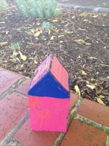 Toy House on Brick Fence