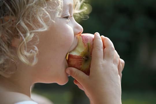 Child eating an apple, a part of healthy eating and fasting as we challenge the cultural traditions of food. (Image © Ableimages/Thinkstock.)