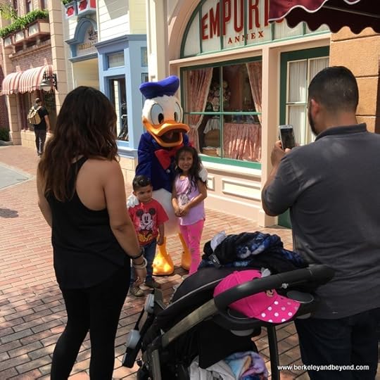 Donald Duck poses with kids at Disneyland