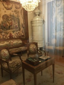 In another drawing room tapestries on the walls matched those on the furniture. And note the stove in the corner-nearly every room had one, some much bigger and more ornate.