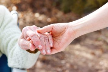 senior-lady-holding-hands-640x426