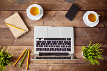 Laptop, cellphone and other business objects on workplace