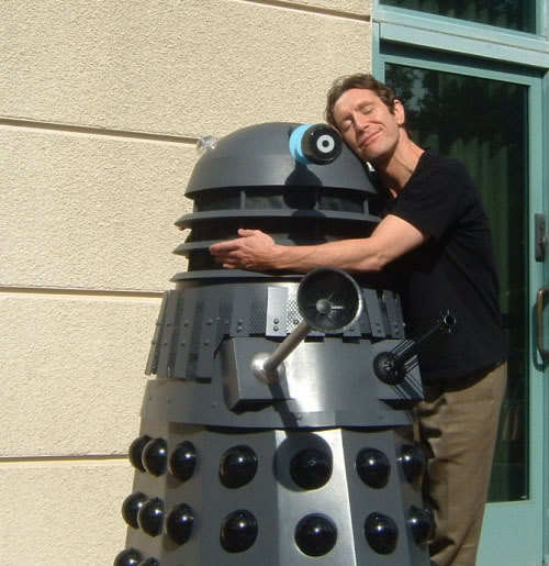 paul mcgann, in civilian clothes, hugging a dalek, a rapturous expression on his face.