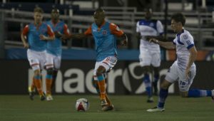 Miami's Ariel Martinez tries to shield the ball from FCE's Daryl Fordyce. PHOTO: MIAMI FC