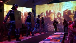 The protestors face off against the Berkut. The performance takes place against a back drop of actual video footage of the Maidan Revolution. 