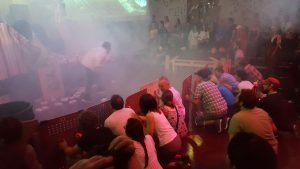 Audience members take cover behind makeshift shields