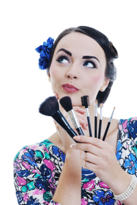 beautiful young pinup woman apply makeup and cosmetics beauty treatment isolated on white in studio