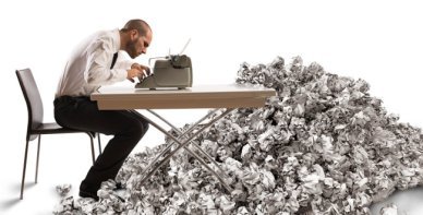 Overworked exhausted businessman writes with a typewriter