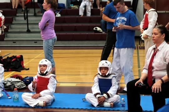 SteelyKid (in blue) waiting for her match at the taekwondo tournament.