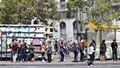 Commuters wait for a bus in San Francisco.