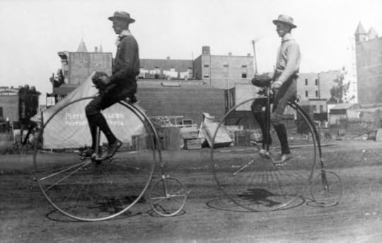 Two men on pennyfarthings, California, 1866. Image via wikipedia