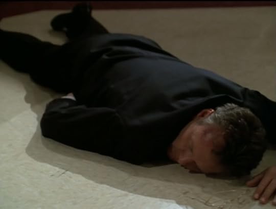 Giles, lying unconscious on the floor.