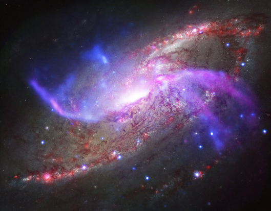 The spiral galaxy NGC 4258, also known as M106, has two extra spiral arms as seen in this undated composite image X-ray data from NASA?s Chandra X-ray Observatory, radio data from the NSF?s Karl Jansky Very Large Array, optical data from NASA?s Hubble Space Telescope and infrared data from NASA?s Spitzer Space Telescope. The image was published in the June 20, 2014 issue of The Astrophysical Journal Letter. REUTERS/NASA/Handout via Reuters (UNITED STATES - Tags: SCIENCE TECHNOLOGY) ATTENTION EDITORS - THIS PICTURE WAS PROVIDED BY A THIRD PARTY. REUTERS IS UNABLE TO INDEPENDENTLY VERIFY THE AUTHENTICITY, CONTENT, LOCATION OR DATE OF THIS IMAGE. THIS PICTURE IS DISTRIBUTED EXACTLY AS RECEIVED BY REUTERS, AS A SERVICE TO CLIENTS. FOR EDITORIAL USE ONLY. NOT FOR SALE FOR MARKETING OR ADVERTISING CAMPAIGNS - RTR3WVJX