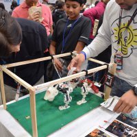 Moore explaining one of his robots. Photo courtesy of Jeffrey Moore