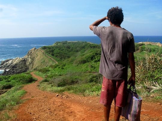 The local fisherman, who gave us fishing lessons, walks down a trail to his favorite fishing spot near Mazunte, Mexico, the site of an authentic cultural experience that enhanced the writer's travel memories (image © Eva Boynton).