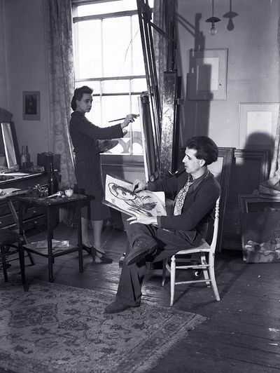 Author and illustrator Mervyn Peake sketches a likeness of his wife painter Maeve Gilmour (Gilmore) while she is working at her easel 1938. (Photo by General Photographic Agency:Getty Images)