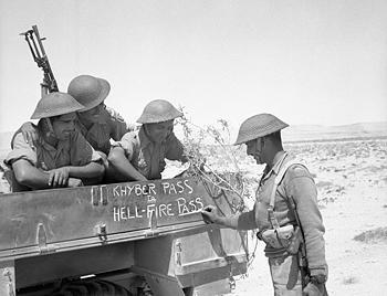 Troops of Indian 4th Division decorating their truck with 'Khyber pass to Hellfire Pass,' noting their service in South Asia and North Africa, 21 Jun 1941 (Imperial War Museum)