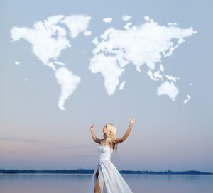 Attractive woman over the cloud world map