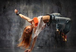 modern style dancer posing behind studio background
