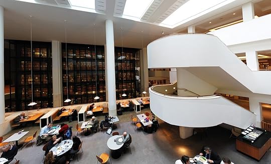 The interior of the British Library, with the smoked glass wall of the King's Library reflecting England's cultural heritage.