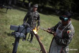 A soldier destroys a rifle with a torch in a military zone in Guatemala City November 15, 2011. The Guatemalan army on Tuesday began the destruction of more than 1,000 firearms collected in 1996 after the signing of a peace deal that ended internal armed conflict, The weapons were delivered by the URNG, or the Guatemalan National Revolutionary Unity, which was a union of the four major guerrilla groups in Guatemala during the conflict. REUTERS/Jorge Dan Lopez (GUATEMALA - Tags: MILITARY POLITICS) - RTR2U2C5