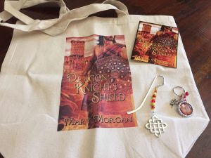 Giveaway: Dragon Knight's Shield Tote, Keychain, Jeweled bookmark, and postcard.