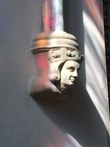Bathed in streaks of late afternoon light through a stained glass window 