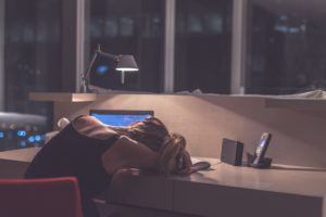 woman sleeping at desk