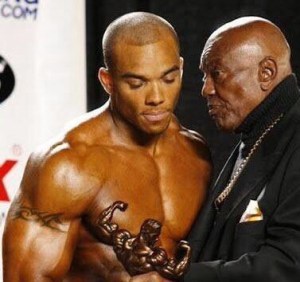 Sergio Oliva Sr and Sergio Oliva Jr share a moment at a bodybuilding show