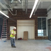 Accent wall in lobby made with reclaimed floor baords from DETAILs. Photo by Will Holman