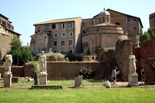 Tourists taking photos of each other in the Forum.