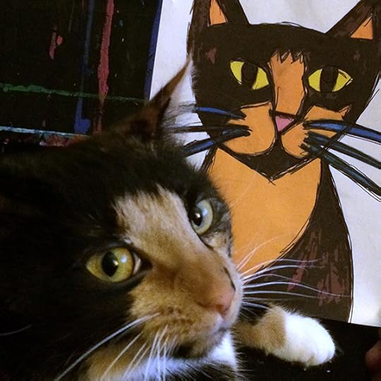 tortoiseshell and white cat poses with painting done of her