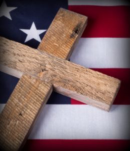 Cross on top of american flag symbolizing memorial day in United States
