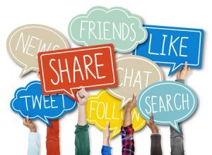 34574488 - group of hands holding speech bubble with social issue concepts