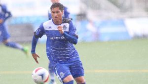 The Eddies' Dustin Corea plays the ball in the driving rain. PHOTO: TONY LEWIS/FC EDMONTON