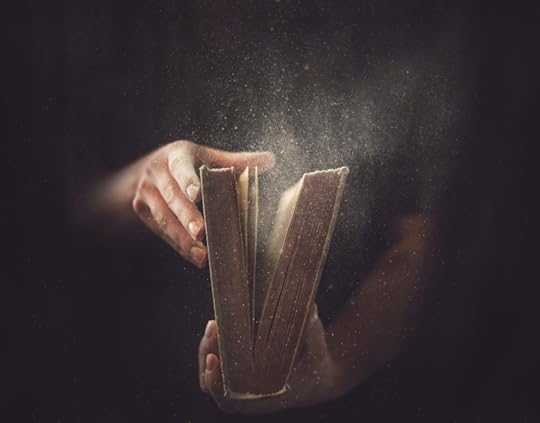 Holding an open book with dust coming out.