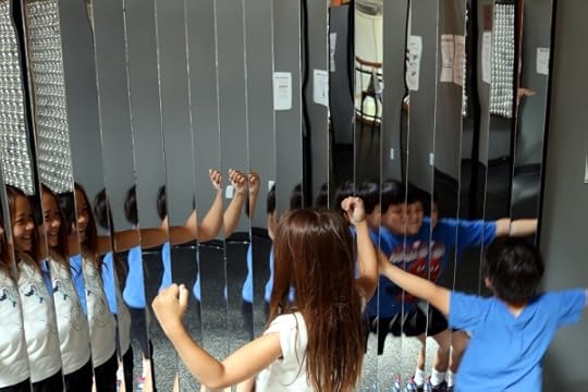 The kids in front of an array of mirrors at the Long Island Children's Museum.