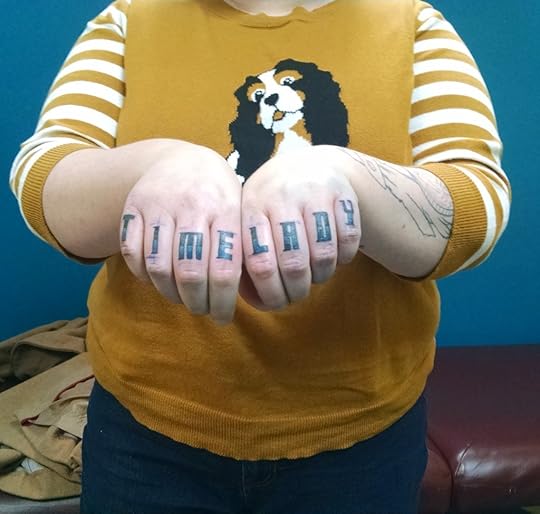 Me, wearing an ugly sweater with a dog on it, showing off fresh knuckle tattoos that spell out 